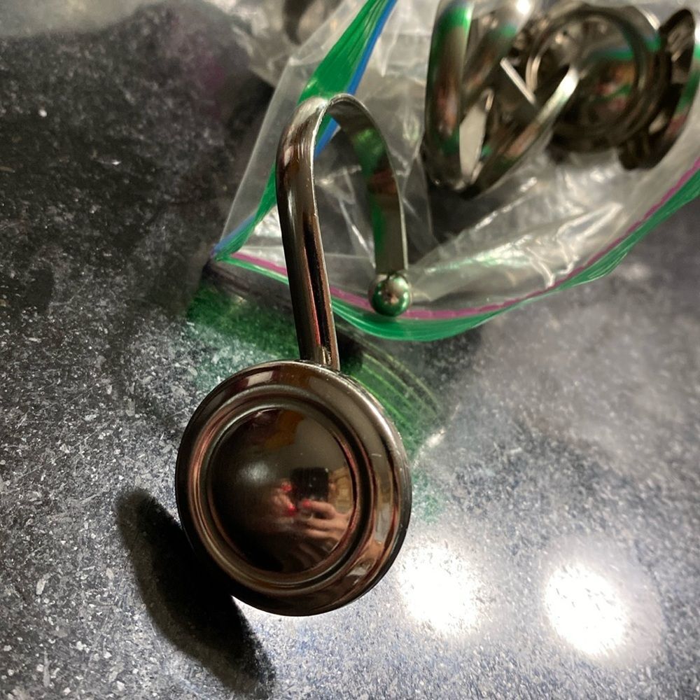 Pack of 12 shower curtain hooks and silver. They look like buttons  pretty.